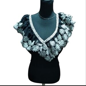 Monograph women's black crop top blouse with embroidered ruffles.